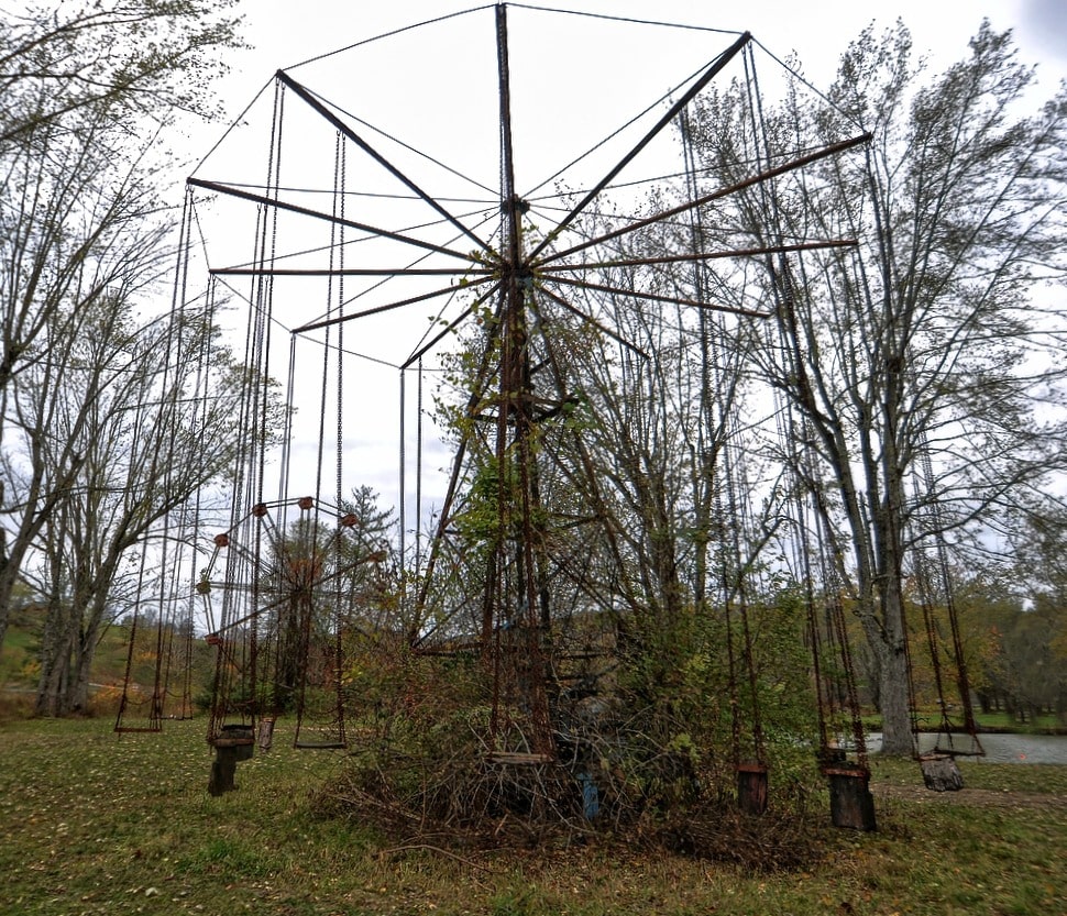 Rusted Ferris wheel standing in bare winter trees at Lake Shawnee Amusement Park, West Virginia